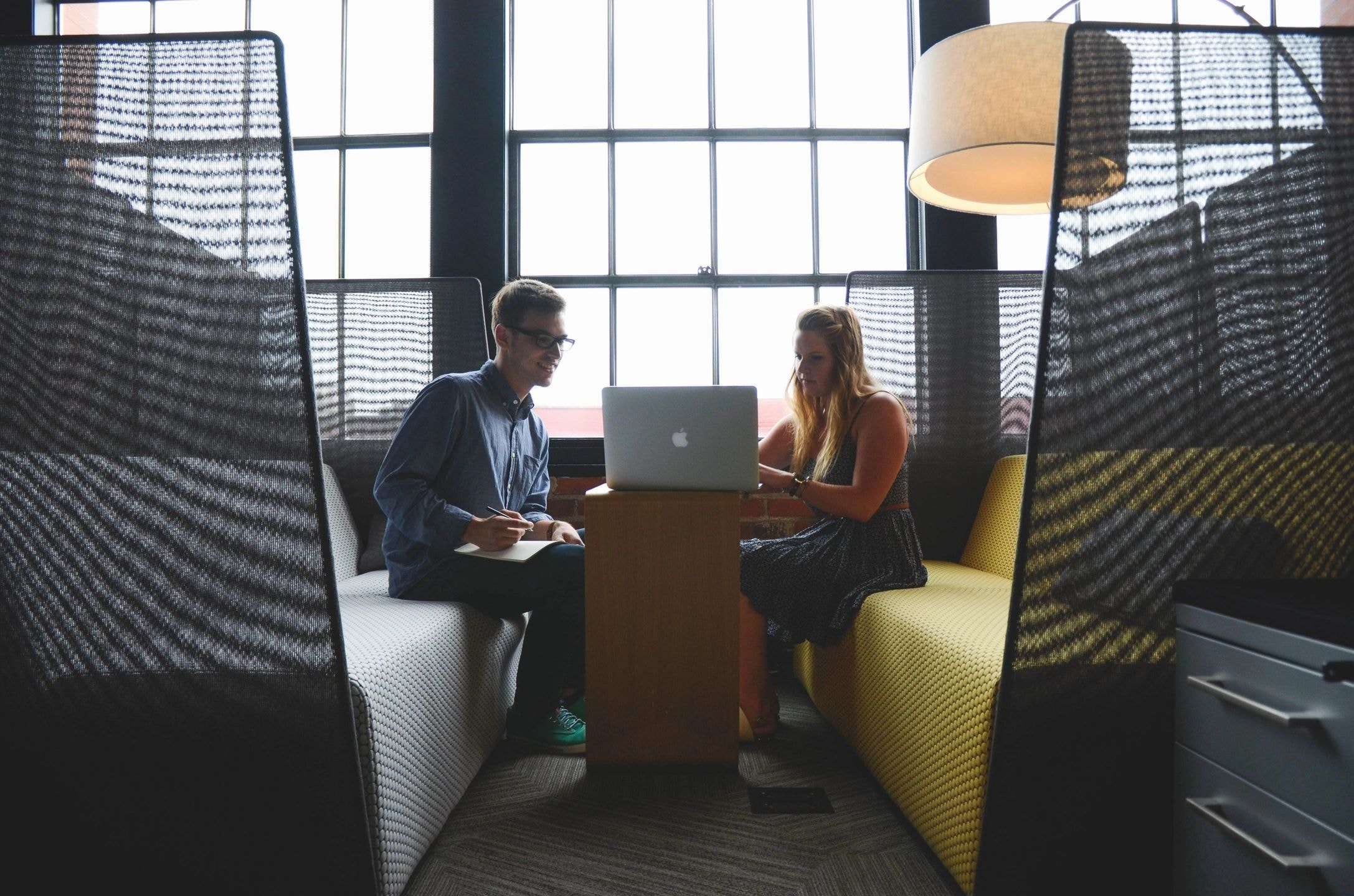 Two professionals collaborating in modern office